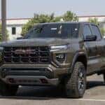 GMC Canyon AT4 pickup display at a dealership. GMC offers the Canyon in Elevation Standard, Elevation, and Denali models.