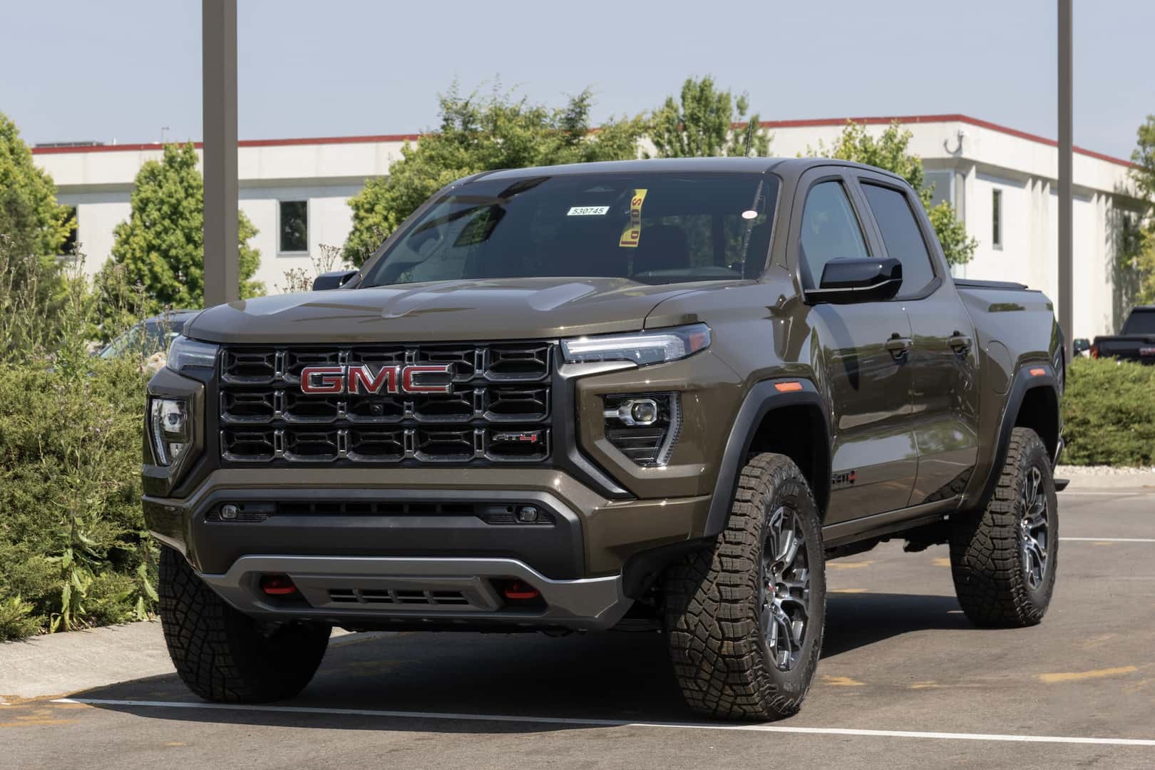 GMC Canyon AT4 pickup display at a dealership. GMC offers the Canyon in Elevation Standard, Elevation, and Denali models.