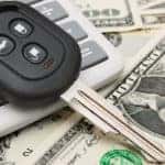 car key on top of calculator and money