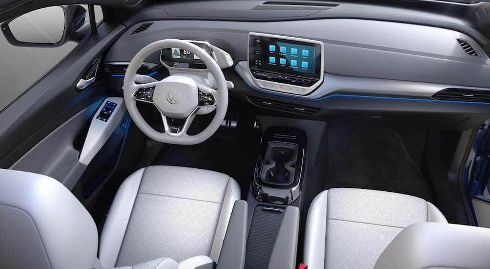 The white and grey interior of a 2021 Volkswagen ID.4 from a VW dealer is shown.