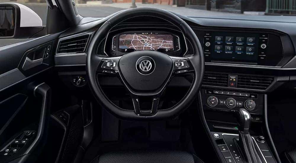 The wheel and technology features are shown inside a 2021 Volkswagen Jetta.