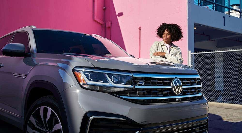 A grey 2022 Volkswagen Atlas SEL R-Line is shown parked in front of a pink wall.