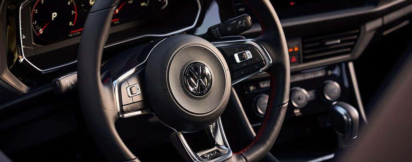 A close up of the steering wheel in a 2022 Volkswagen Jetta GLI is shown at a Burien Volkswagen dealer.
