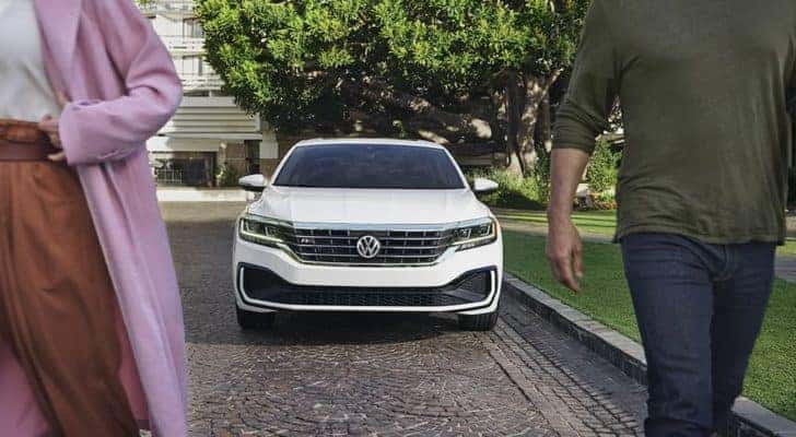 A white 2022 Volkswagen Passat R is shown from the front parked on the side of a street.