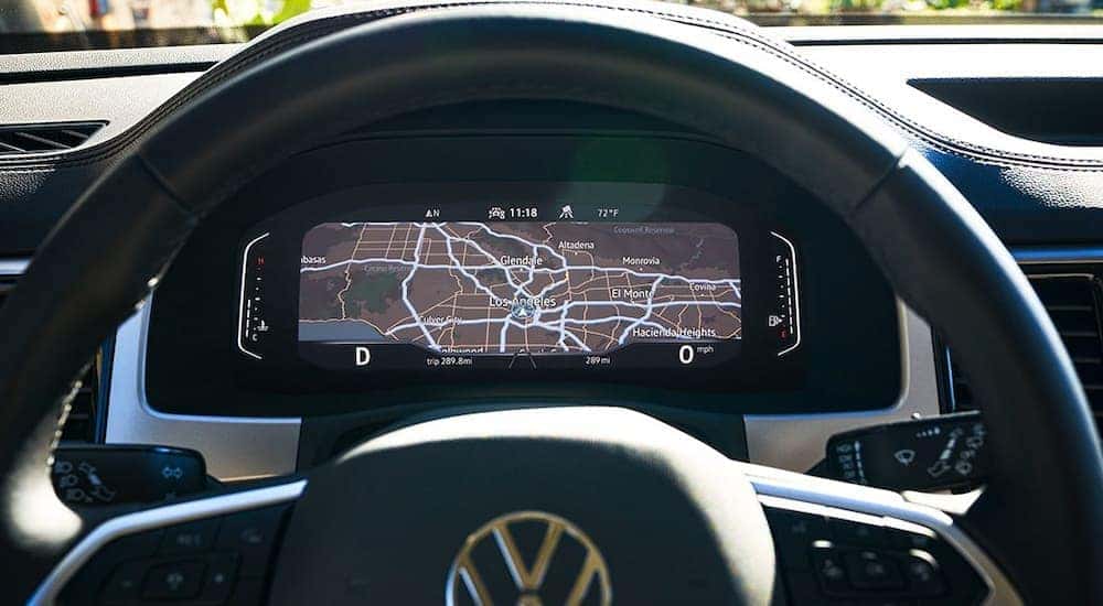 A close up of the steering wheel and dashboard of a 2022 Volkswagen Atlas is shown at a Bud Clary Auburn VW dealer.