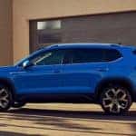 A blue 2023 Volkswagen Taos SEL is shown from the side while parked.