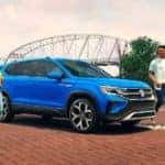 A blue 2023 Volkswagen Taos is shown in a park after leaving a VW Taos dealer.