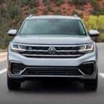 A silver 2023 Volkswagen Atlas Premium R-Line is shown from the front driving.