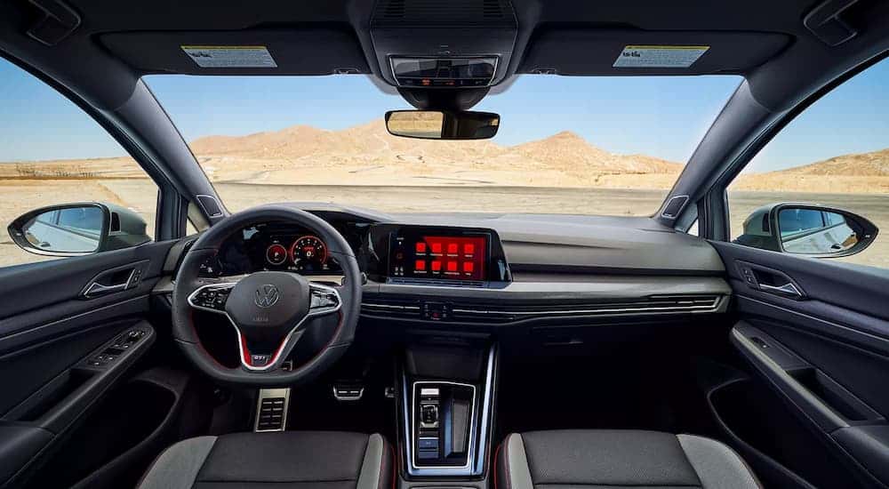The black and grey interior of a 2023 Volkswagen Golf GTI is shown.