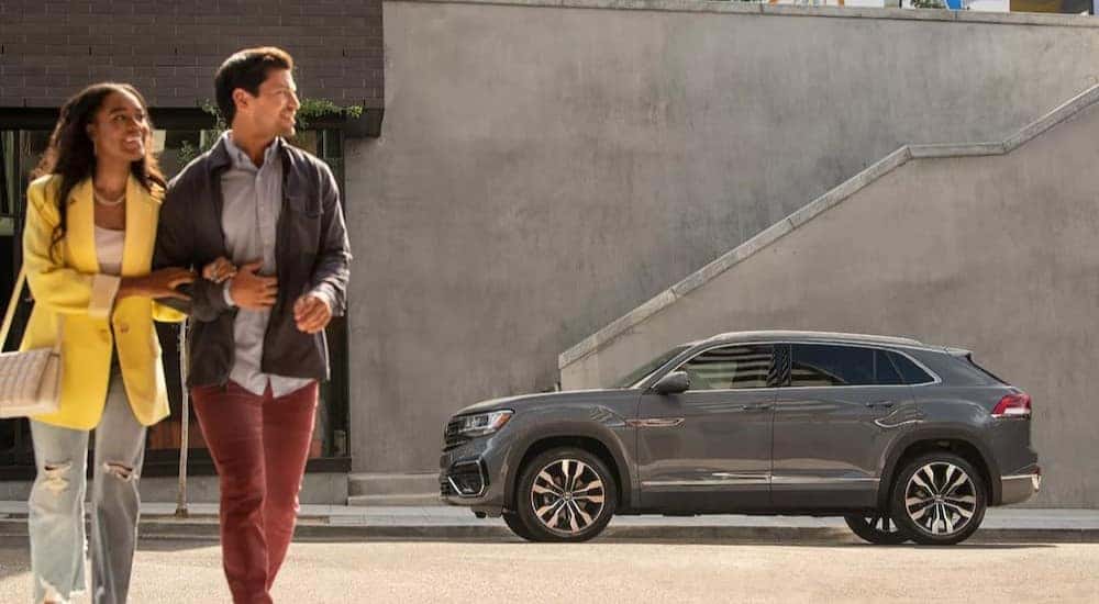 A 2023 Volkswagen Atlas Cross Sport is shown parked near stairs.