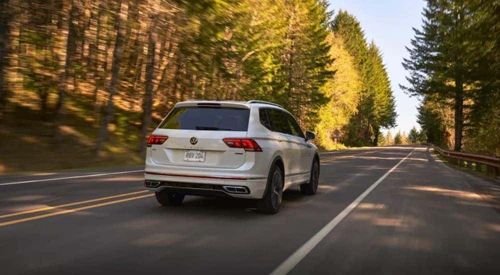 A white 2023 Volkswagen Tiguan is shown from the rear at an angle.