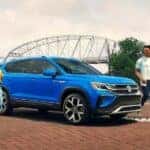 A blue 2023 Volkswagen Taos is shown parked near a bridge after winning a 2023 Volkswagen Taos vs 2023 Toyota Corolla Cross comparison.