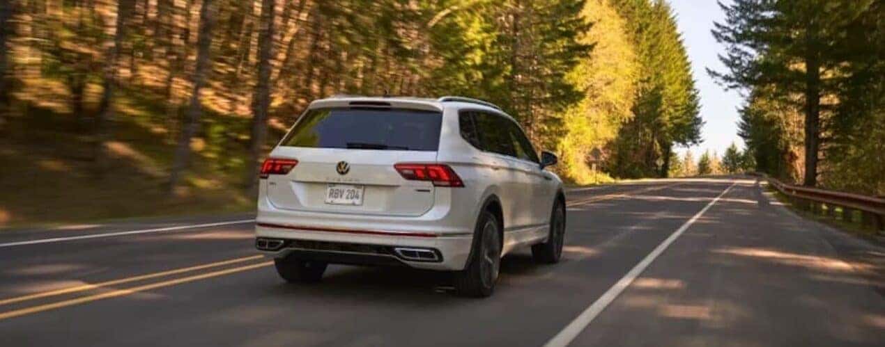 A white 2023 Volkswagen Tiguan is shown from the rear at an angle.