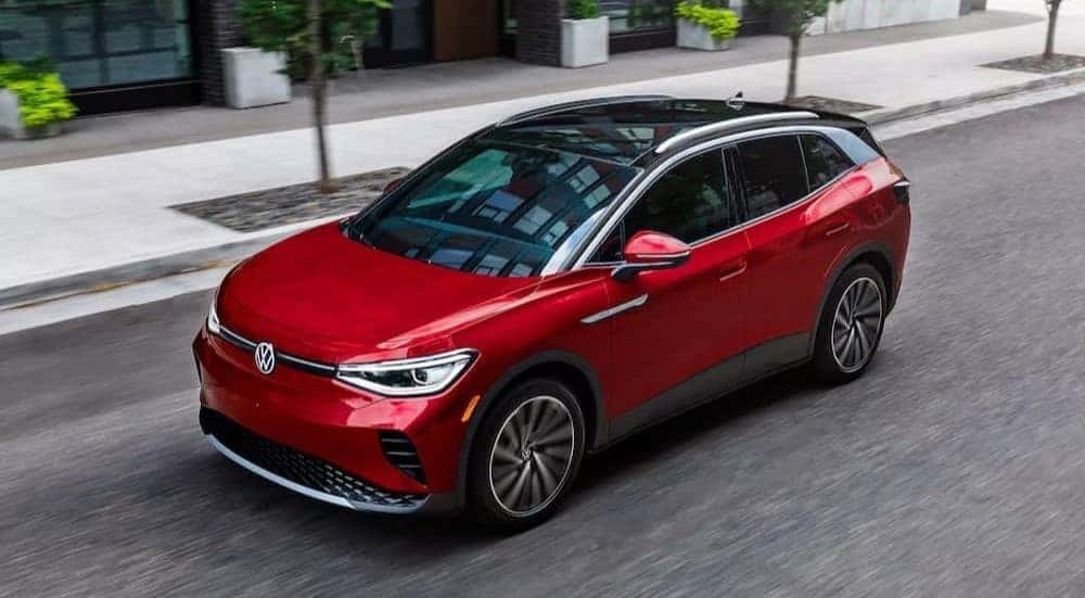 A red 2023 Volkswagen ID.4 Pro S is shown driving on a city street.
