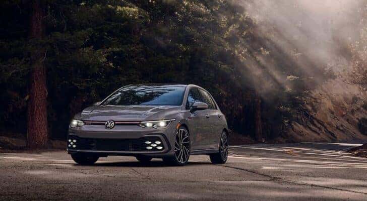 A grey 2022 Volkswagen Golf GTi is shown from the front at an angle.