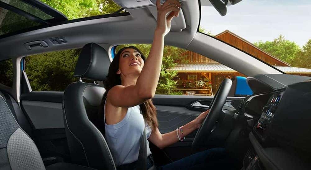 The black and gray interior and dash of a 2024 Volkswagen Taos is shown.