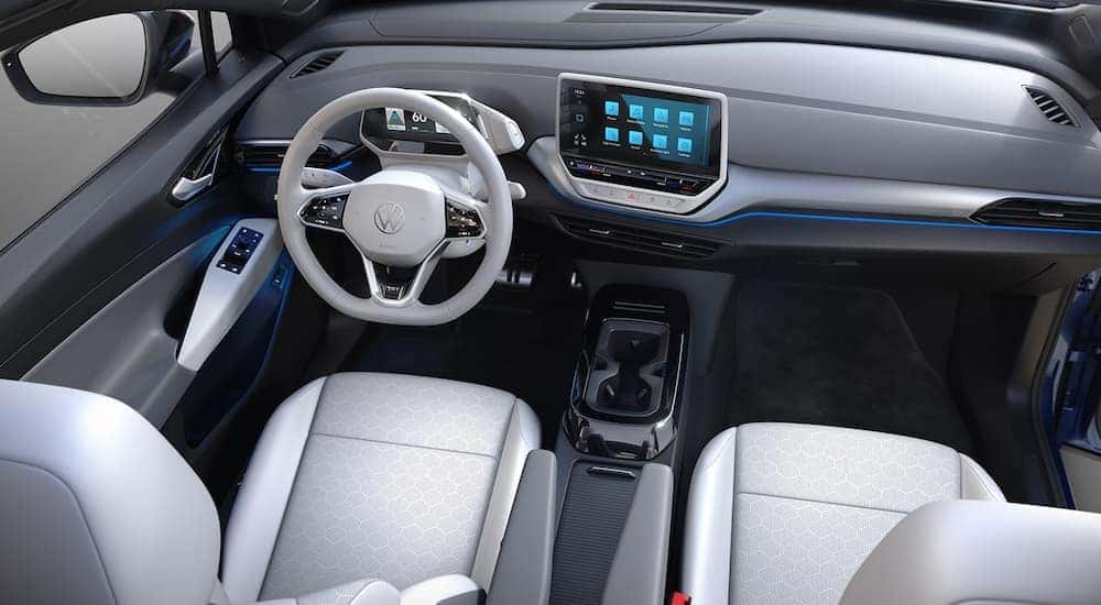 The white interior of a 2024 Volkswagen ID.4 is shown from a high angle above the center console.