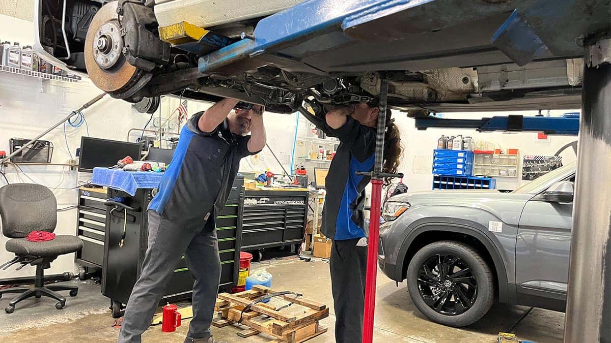 Two certified Volkswagen technicians working on a VW