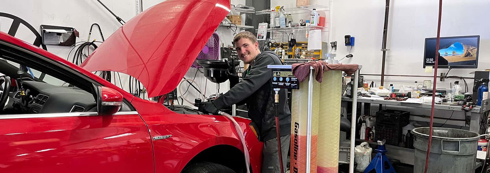 volkswagen technician working on a red vw vehicle at Bud Clary Auburn VW