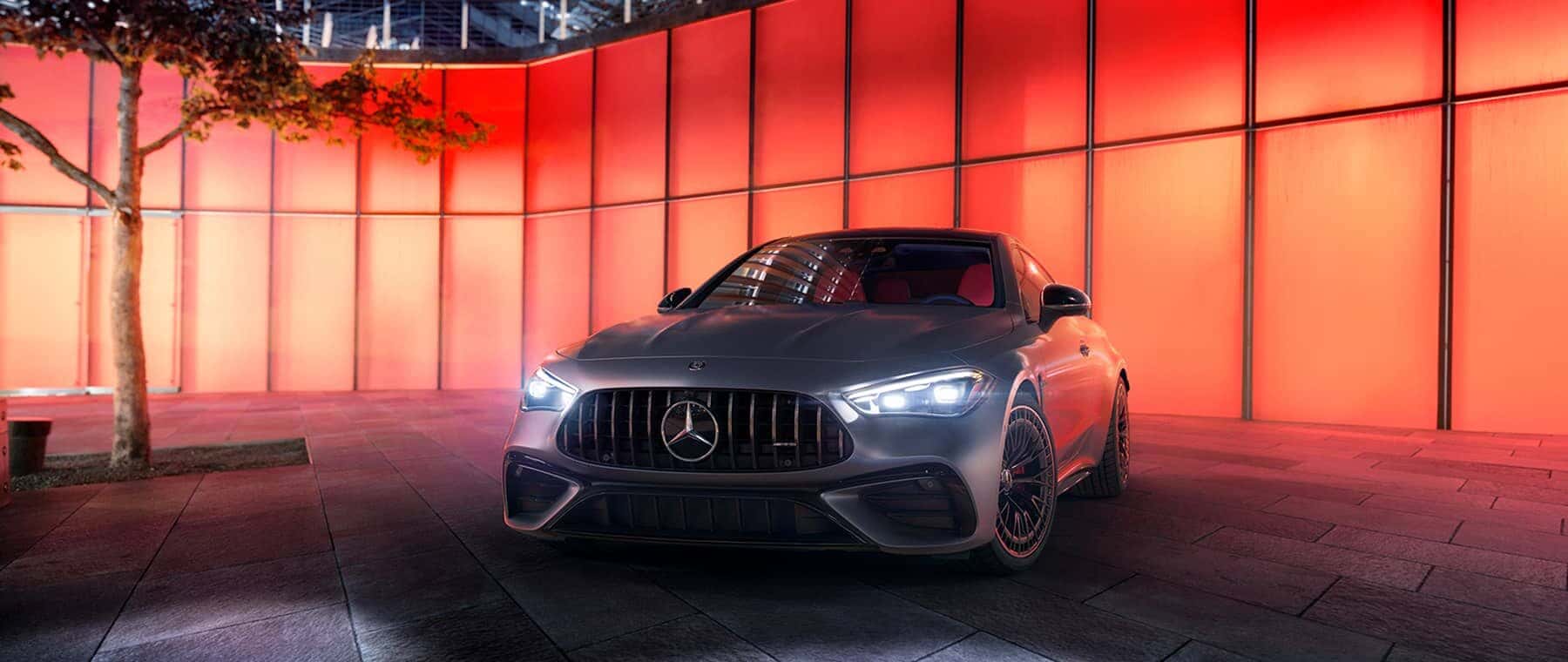 Sedan parked in front of red wall