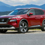 A Red 2023 Nissan Rogue against a natural backdrop