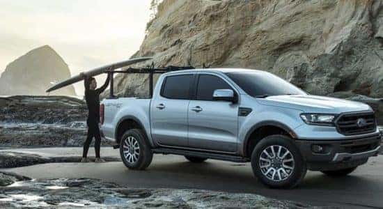 Ford Ranger Parked at Beach with Surfer Getting Board off Bed Rack