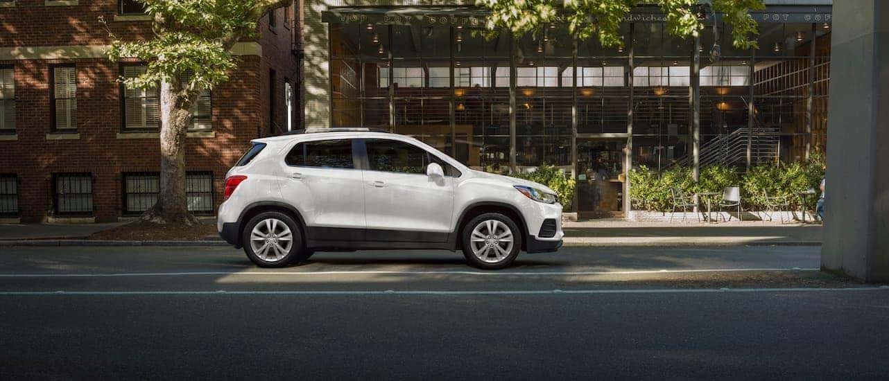 A white 2021 Chevy Trax is parked outside a cafe near Lexington and shown from the side.