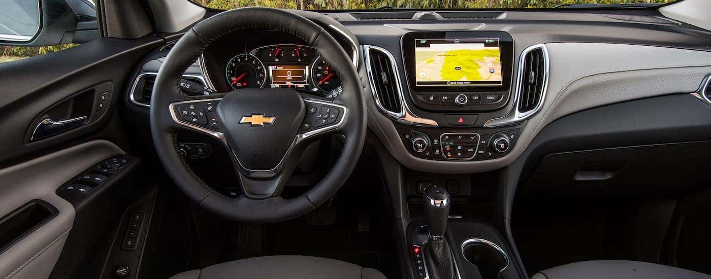 The steering wheel and dashboard of a 2020 Chevy Equinox are shown.