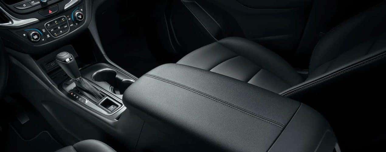 A close up shows the black leather interior and center console in a 2021 Chevy Equinox.