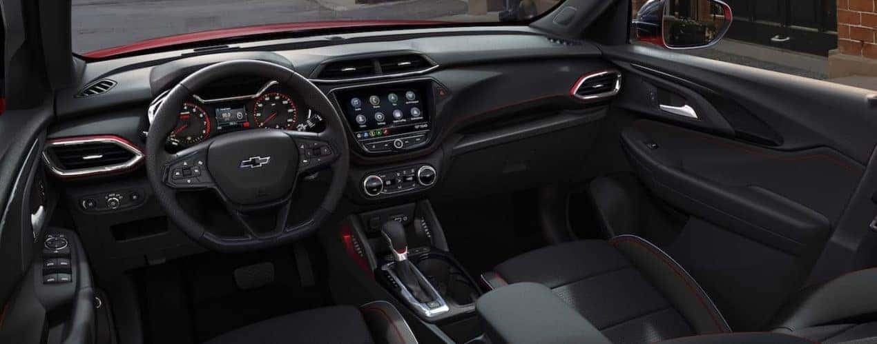 The black interior and front seats are shown in a red 2021 Chevy Trailblazer RS.