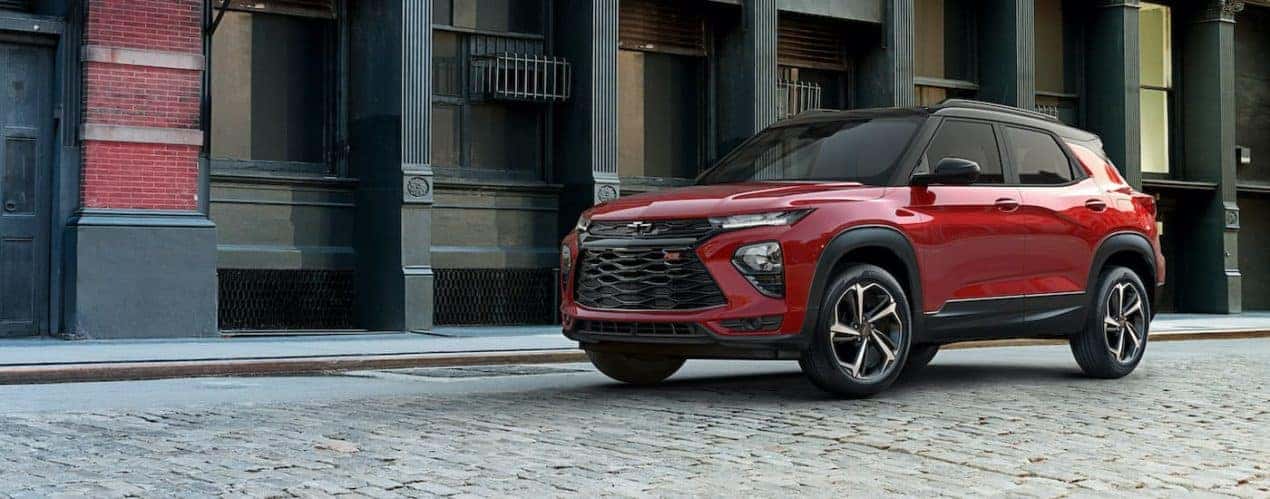 A red 2021 Chevy Trailblazer RS is shown from the side parked on a cobblestone street.