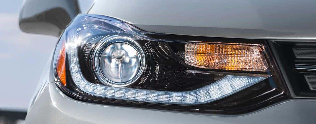 A close up shows the passanger headlight on a silver 2022 Chevy Trax.