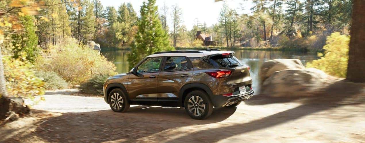 A bronze 2022 Chevy Trailblazer ACTIV is shown from the side parked next to a lake.