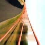 1st person point of view of a roller coaster with orange rail tracks