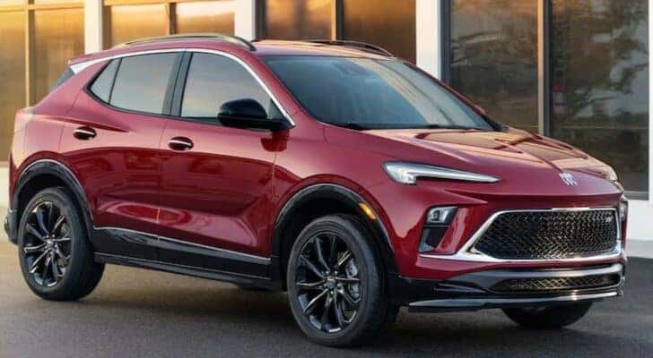 A red 2024 Buick Encore GX Sport Touring Edition is shown parked near a Buick dealer near Shelbyville.