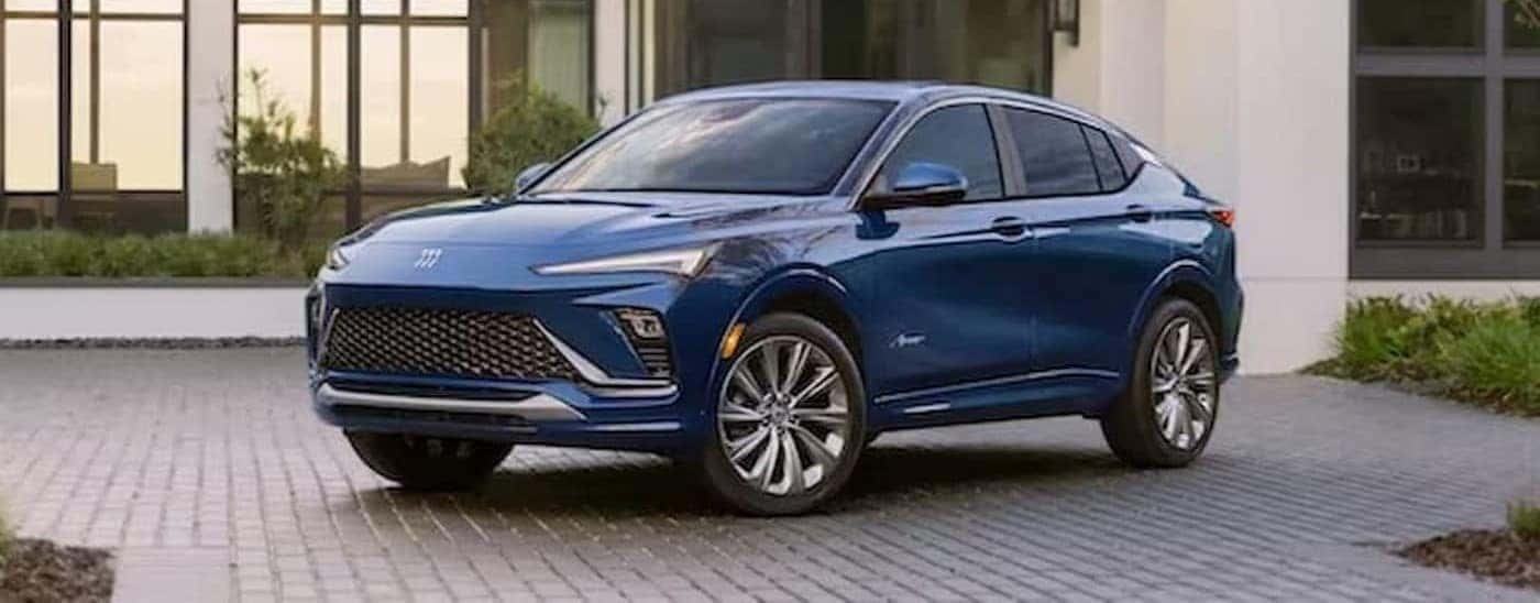 A blue 2024 Buick Envista is shown parked near a building.