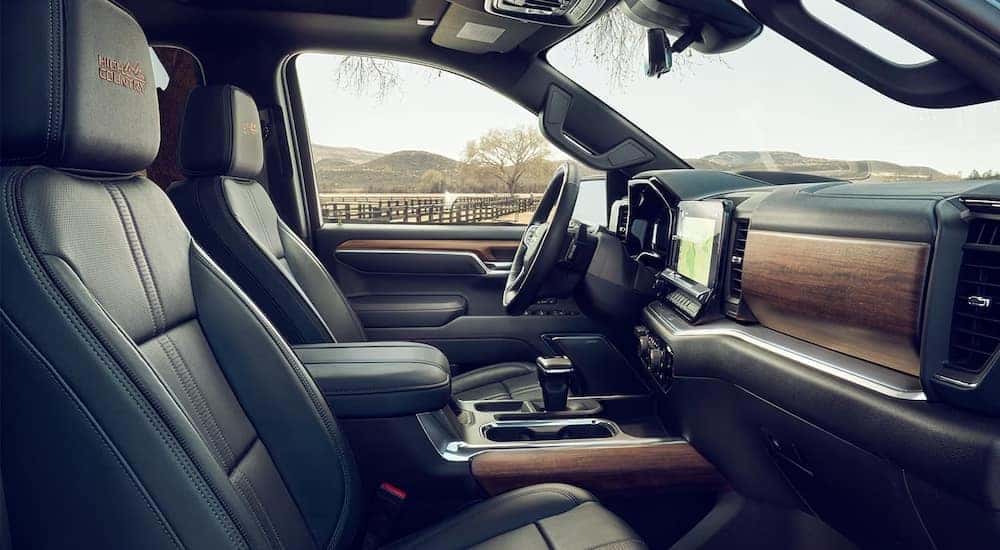 The black-and-brown interior of a 2024 Chevy Silverado 1500 High Country is shown.