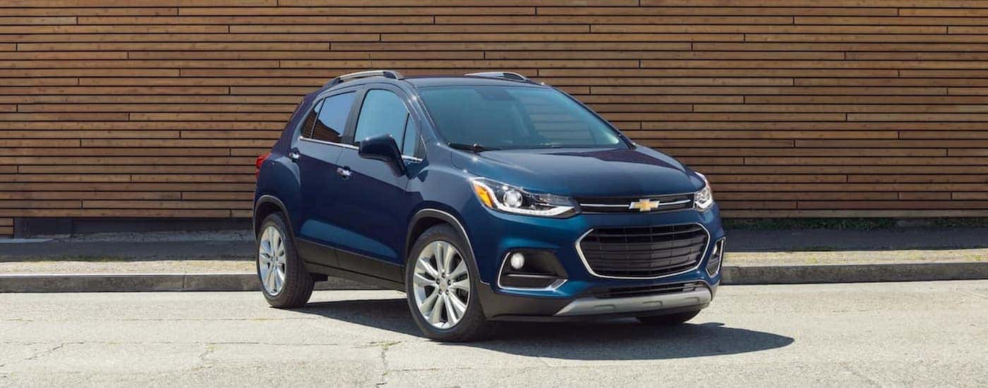 A blue 2019 Chevy Trax is shown parked near a curb.