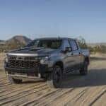 A silver 2024 Chevy Silverado 1500 ZR2 is shown from the front at an angle after leaving a dealer that has a Chevy Silverado for sale.