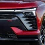 A close up of the grille on a red 2024 Chevy Blazer EV SS is shown.