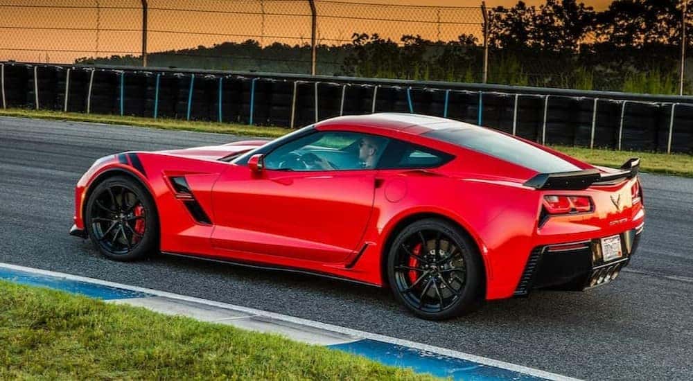 A red 2017 Chevrolet Corvette C7 Grand Sport is shown driving on a track after viewing a used Chevy dealership near Cynthiana.