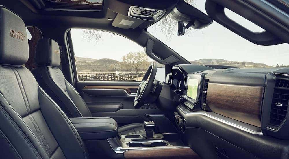 The leather and wood interior of a 2024 Chevy Silverado 1500 High Country for sale near Danville.