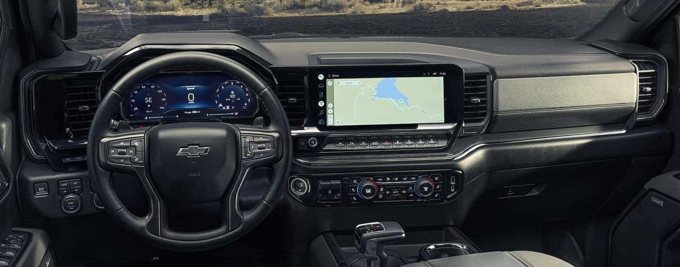 The steering wheel and dashboard in a 2024 Chevy Silverado 1500 for sale near Danville.
