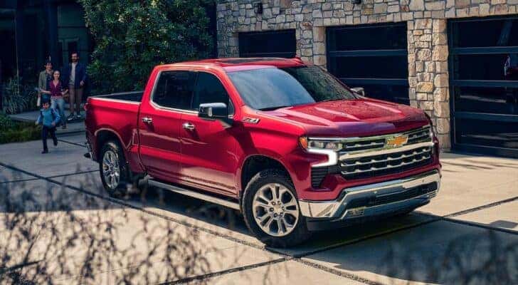 A red 2024 Chevy Silverado 1500 Z71 parked on a residential driveway.