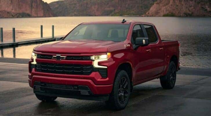 A red 2024 Chevy Silverado 1500 Z71 RST is shown parked after visiting a Chevy dealer near Florence.