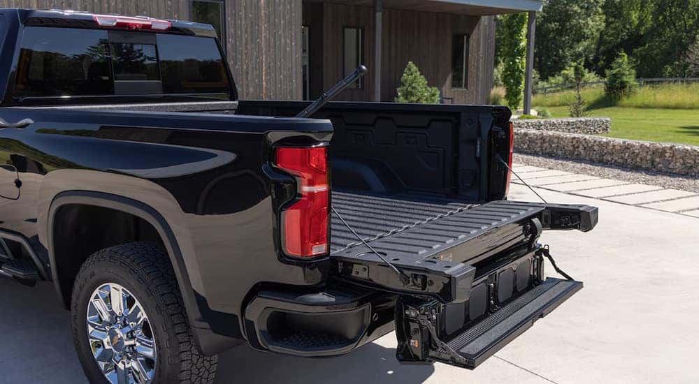 A Multi-Flex tailgate on the back of a black 2024 Chevy Silverado 2500 HD.