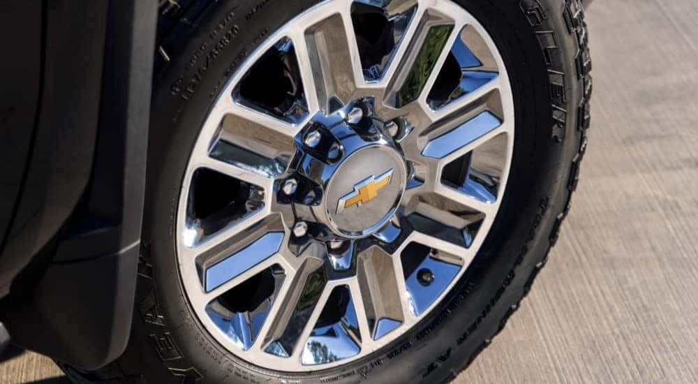 A close-up of a wheel on a 2024 Chevy Silverado 2500HD High Country is shown.