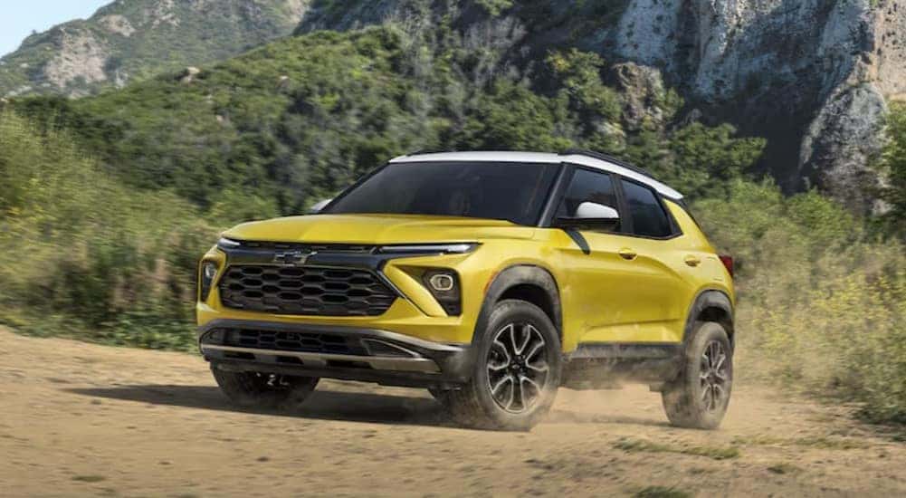 A yellow 2024 Chevy Trailblazer ACTIV is shown driving off-road.