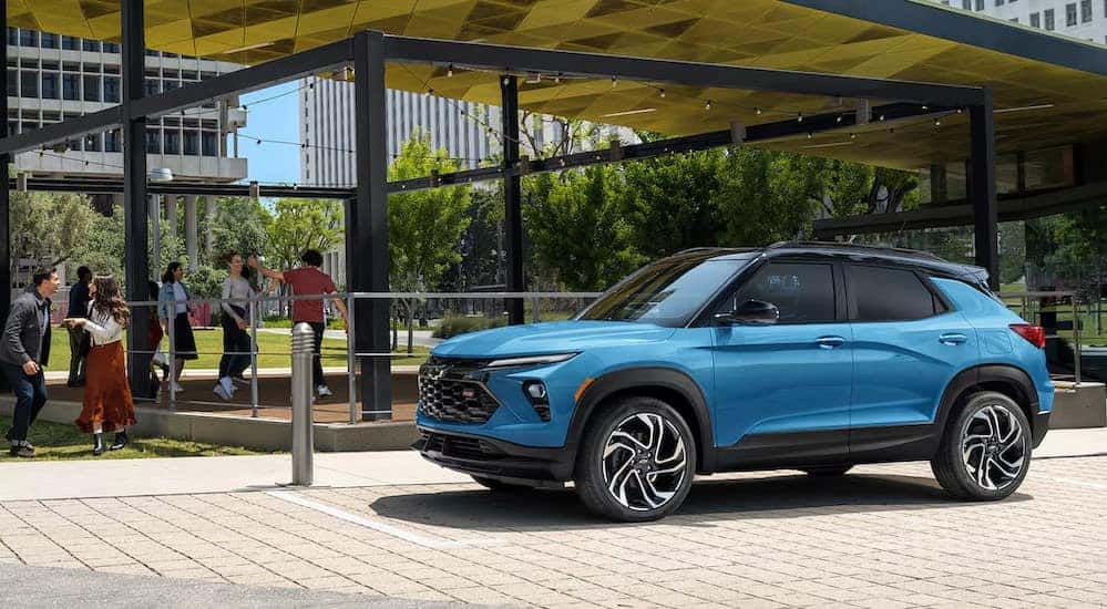 A blue 2024 Chevy Trailblazer RS is shown parked near a Chevy dealer near Covington.