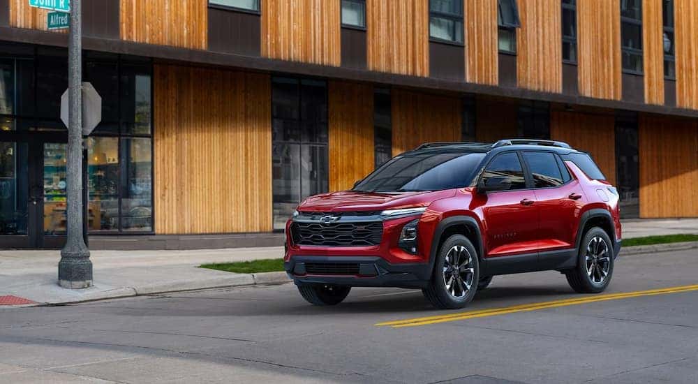 A red 2025 Chevy Equinox RS is stopped at an intersection.